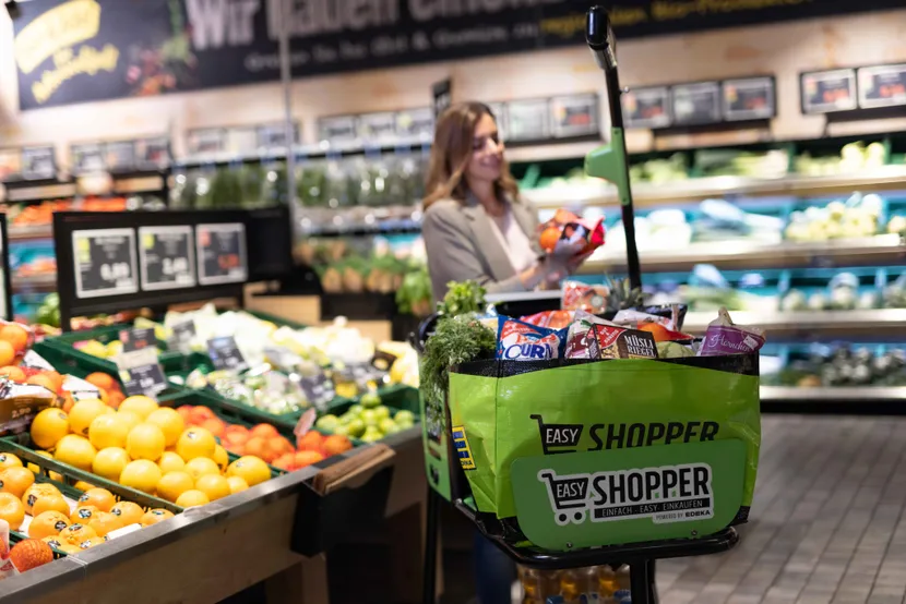 A woman scanning her groceries at a smart shopping cart (EASY Shopper)
Image: Jonathan Fafengut / EDEKA Minden-Hannover